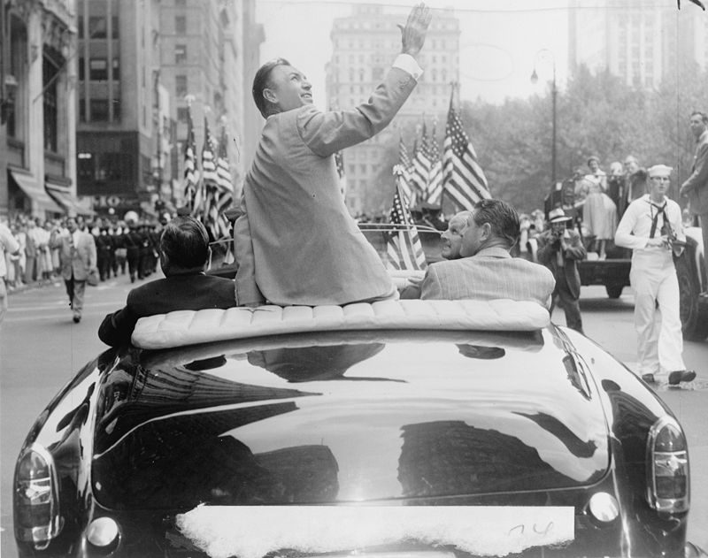 Ben Hogan seated on back of car in homecoming parade on Broadway