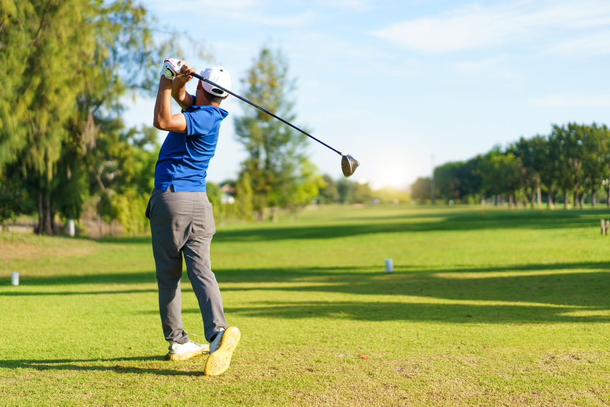 an amateur golfer playing golf at golf course in morning