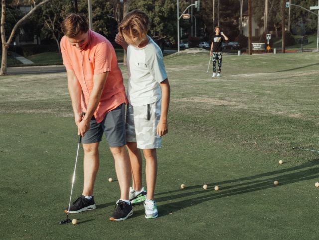 Father and son playing golf