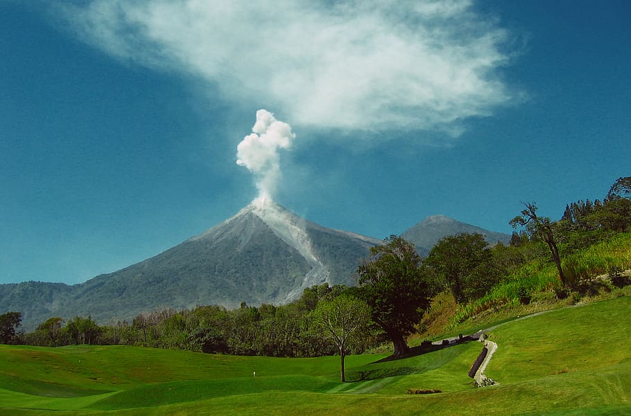 Mount Merapi in the background of a golf course