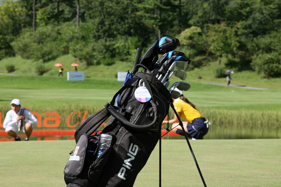 a golf bag with golf clubs and other items