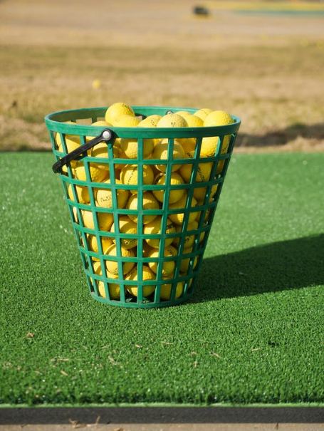 blue-plastic-basket-on-green-grass-field