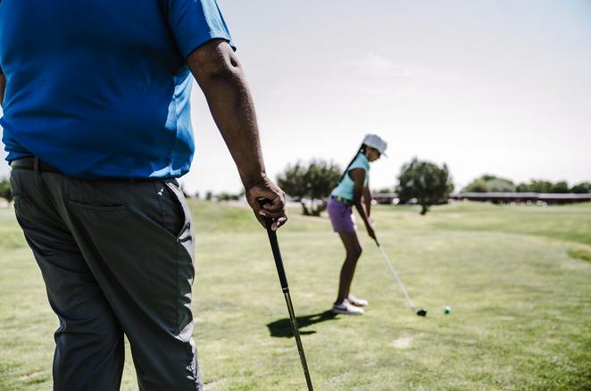 Child learning to play golf