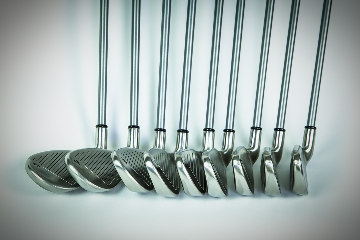 A set of graphite golf clubs neatly displayed