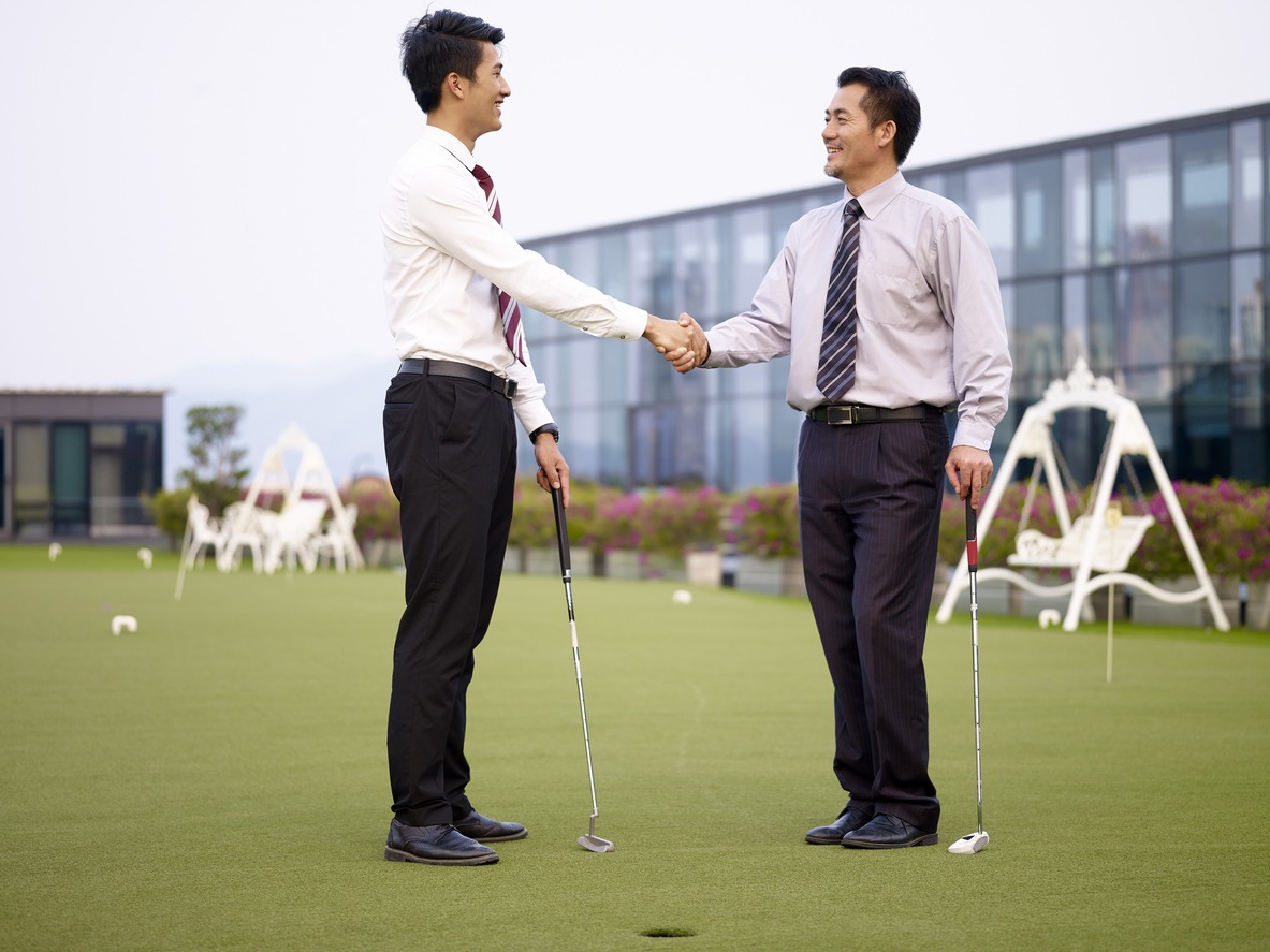 Businessman getting to know each other in a golf course